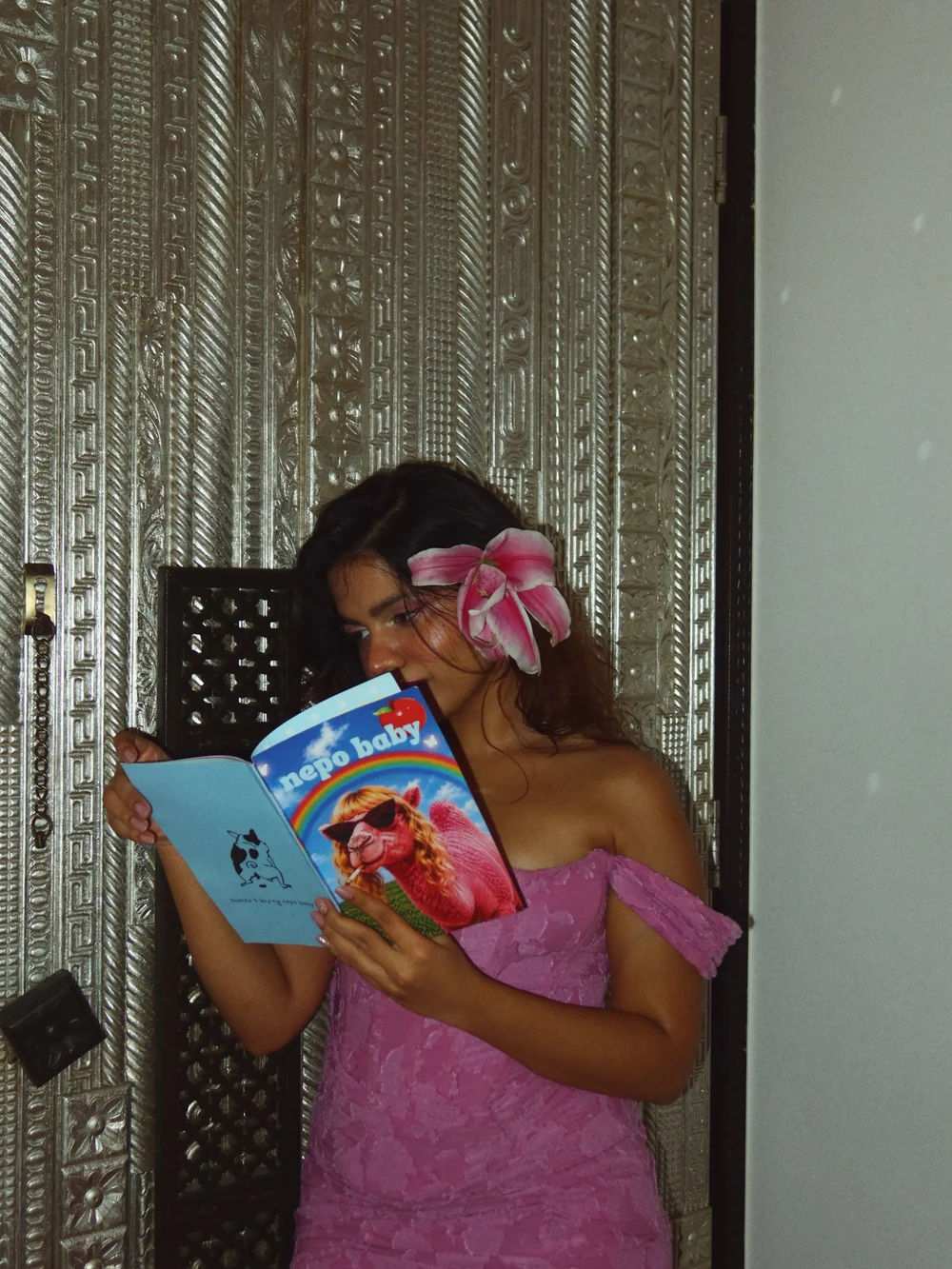 Srishti holding a photographed copy of Nepo Baby Magazine